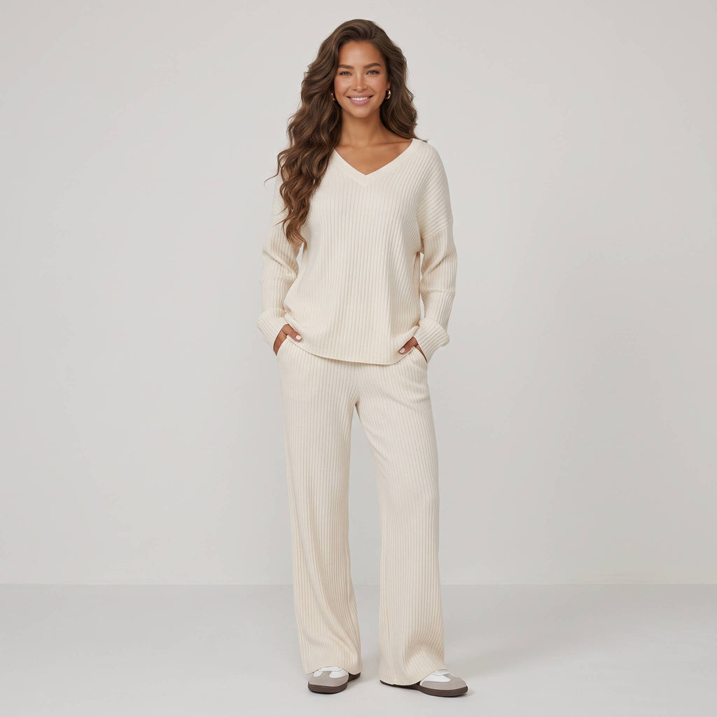 Woman wearing cream 2-piece ribbed knit loungewear set with V-neck long-sleeve top and straight-leg trousers